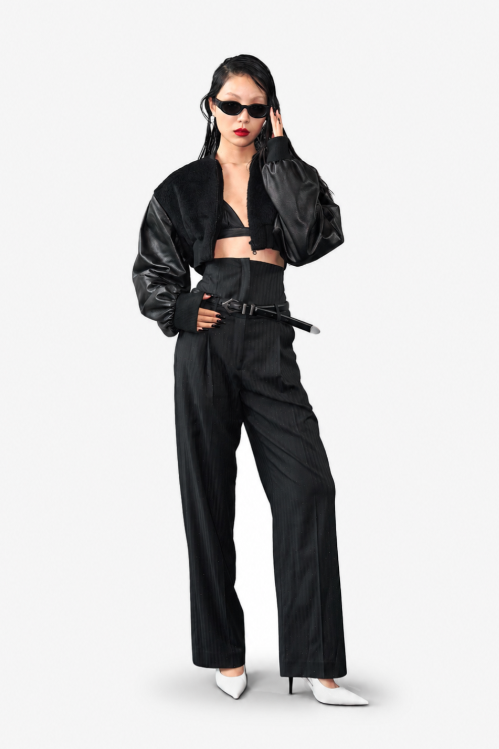 Model wearing the Cropped Alpaca and Leather Bomber Jacket styled with high-waisted tailored trousers and white pointed heels, showcasing a bold sculptural silhouette with SHAO New York bespoke tailoring influences.