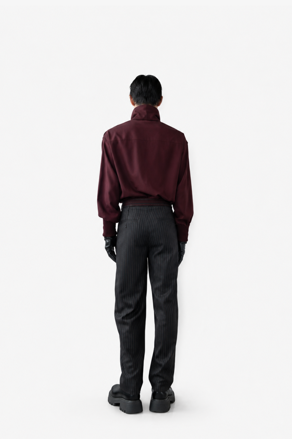 Model wearing Tailored Wool Balloon Bomber Jacket - Burgundy with a high structured collar and voluminous sleeves, paired with pinstriped tailored trousers and black leather gloves, showcasing SHAO New York bespoke tailoring and a modern sculptural silhouette.