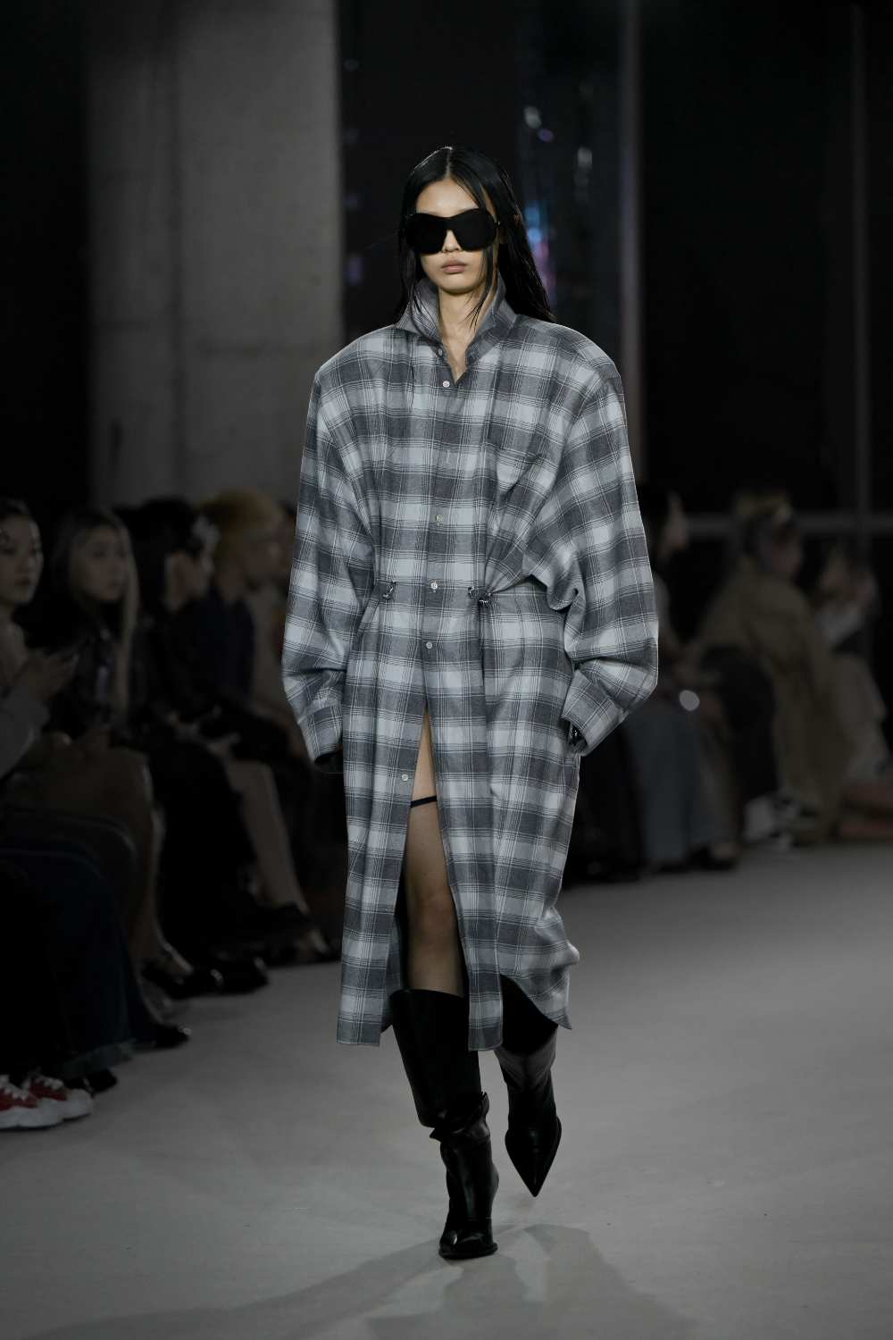 Mid Rise Boots Vegan Leather featuring a pointed toe and sculptural heel, styled with a long grey plaid coat dress with oversized sleeves, embodying refined luxury and New York designer tailoring.