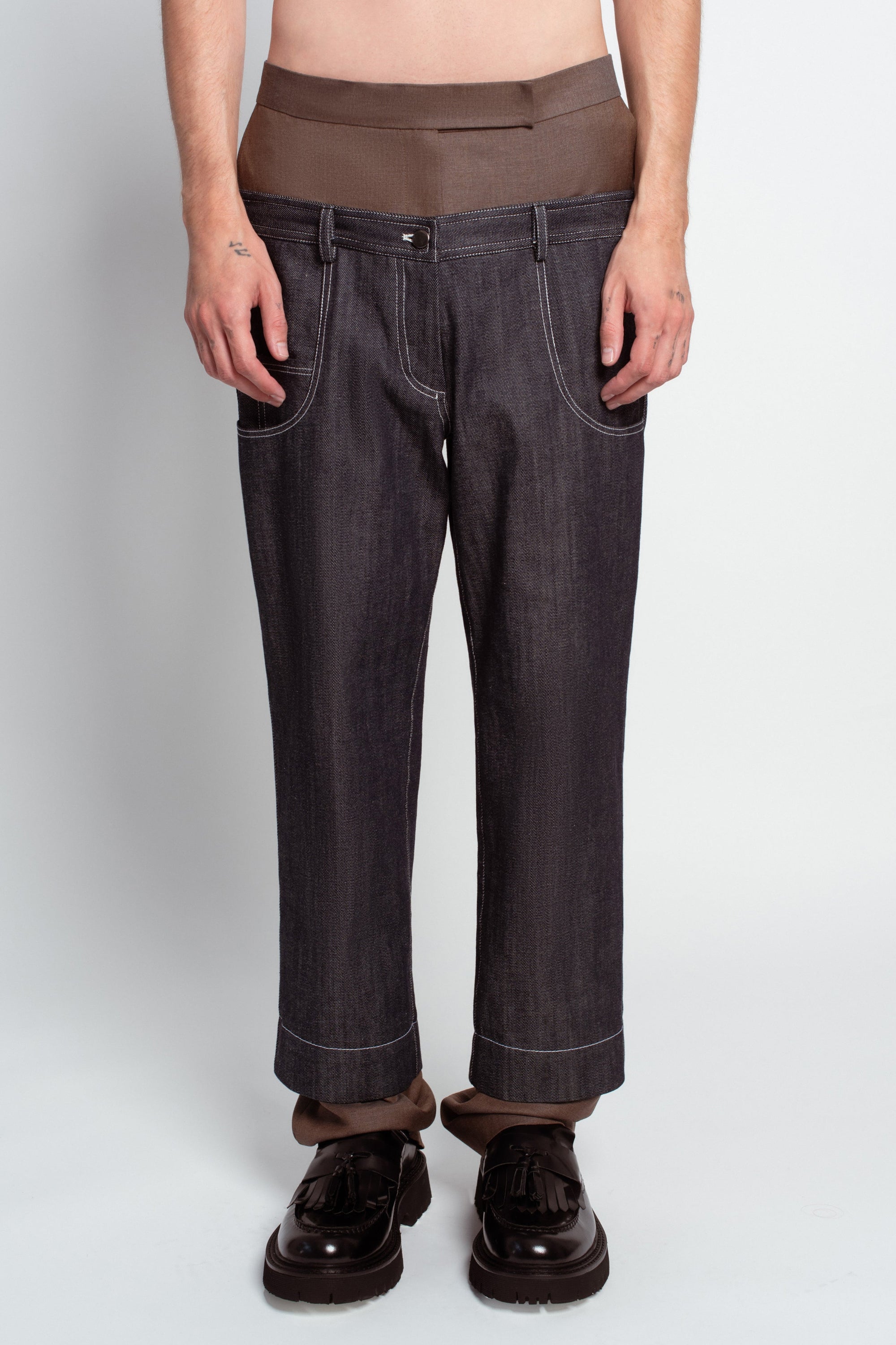 Blue denim trousers with warm brown base layer detail