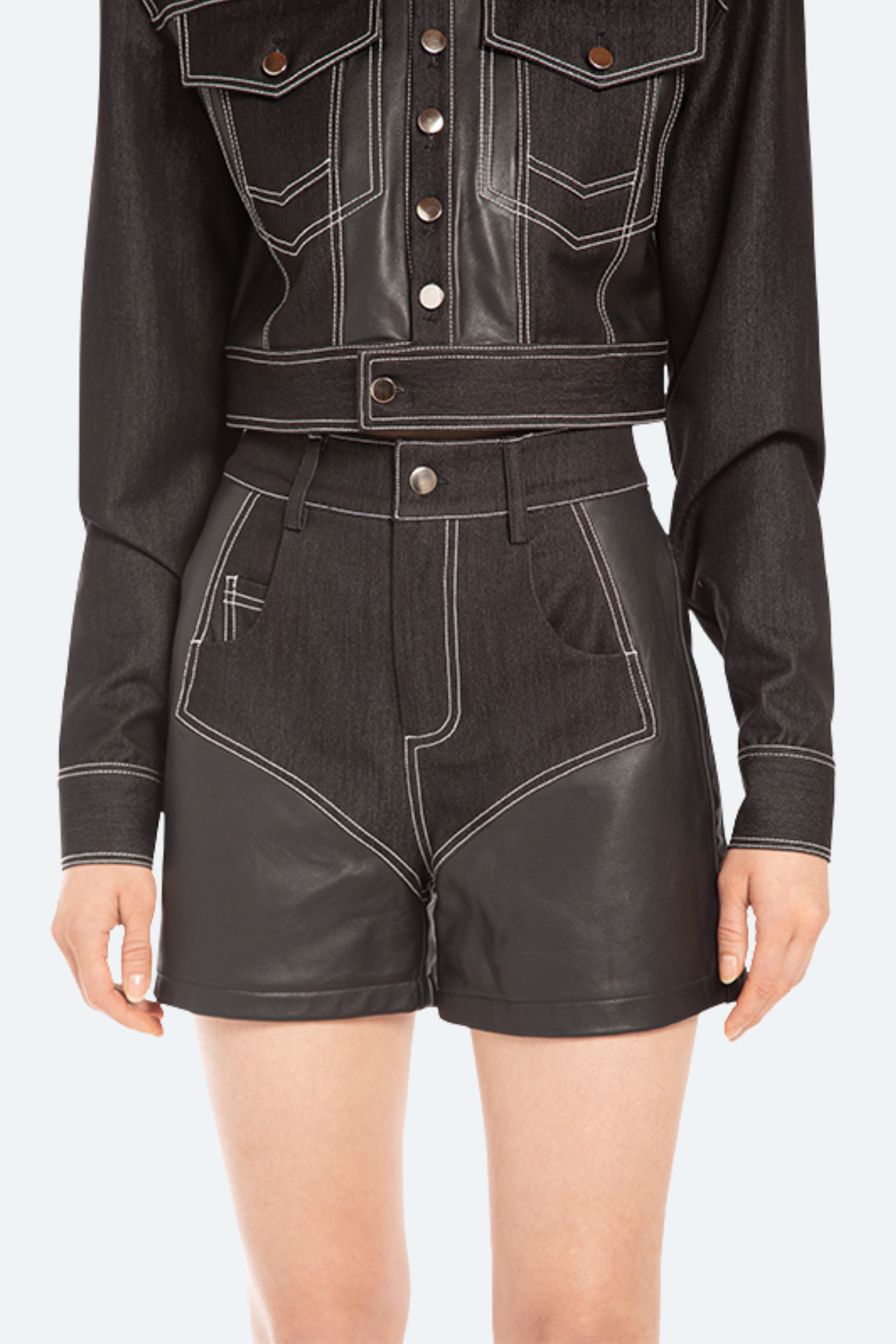 Front view of black high-waist denim shorts with contrast white stitching and slim tailored silhouette