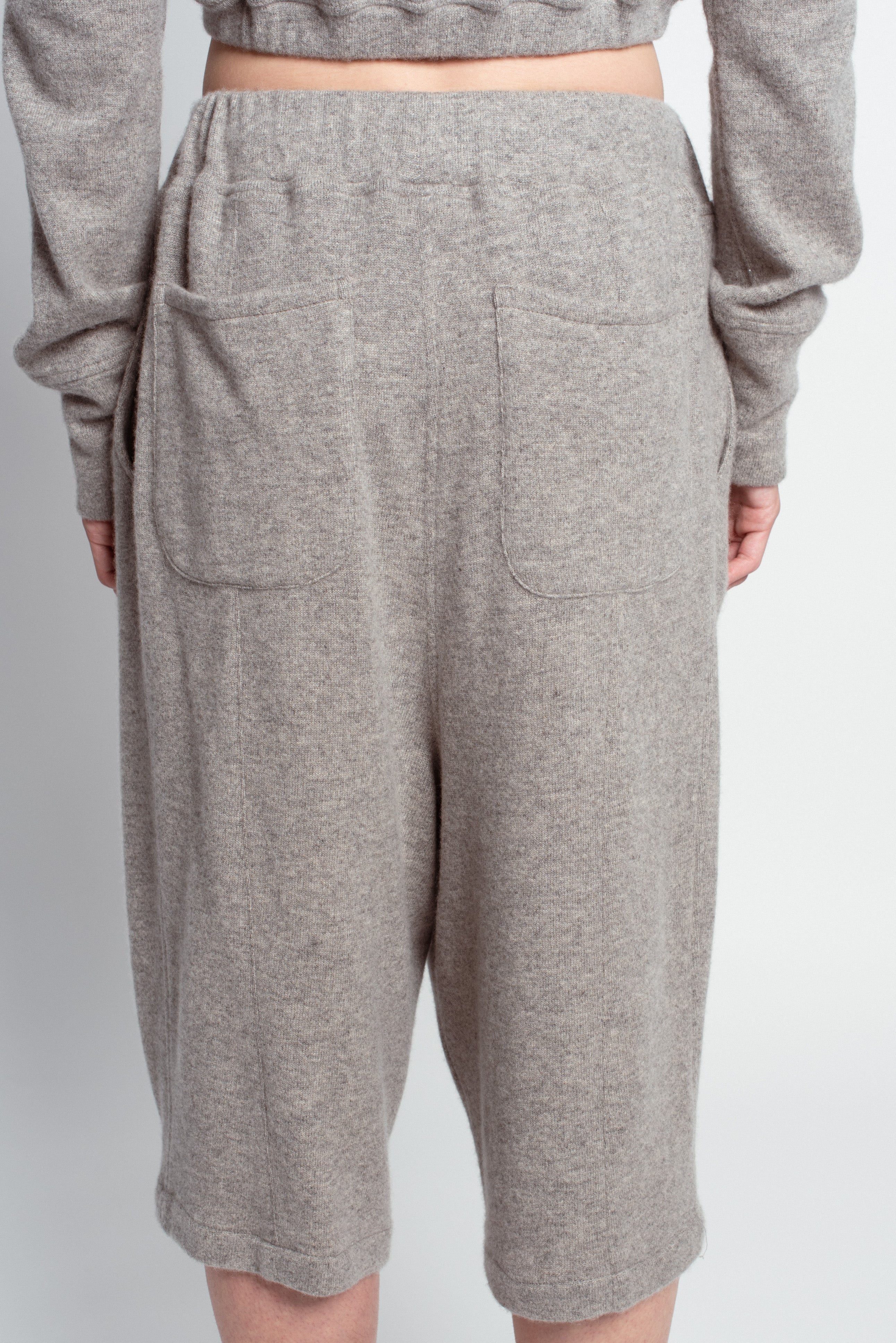 Back view of Grey Cashmere Wide-Leg Pants featuring a comfortable elastic waistband, two large patch pockets, and soft breathable fabric, highlighting SHAO New York bespoke tailoring.