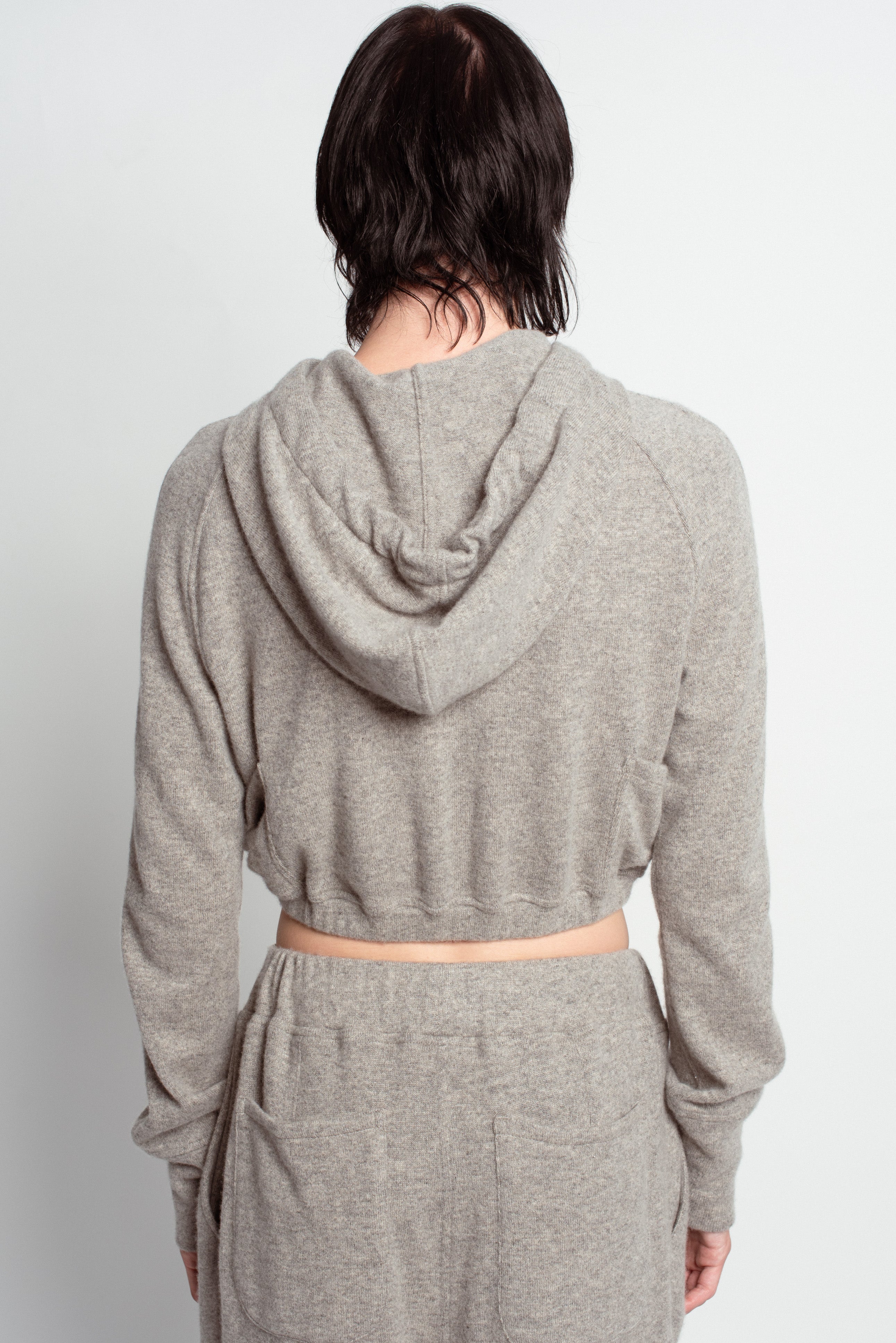 Back view of Grey Cropped Cashmere Hoodie with a soft hood, long sleeves, and a relaxed cropped fit, highlighting SHAO New York bespoke tailoring and luxury designer fashion.