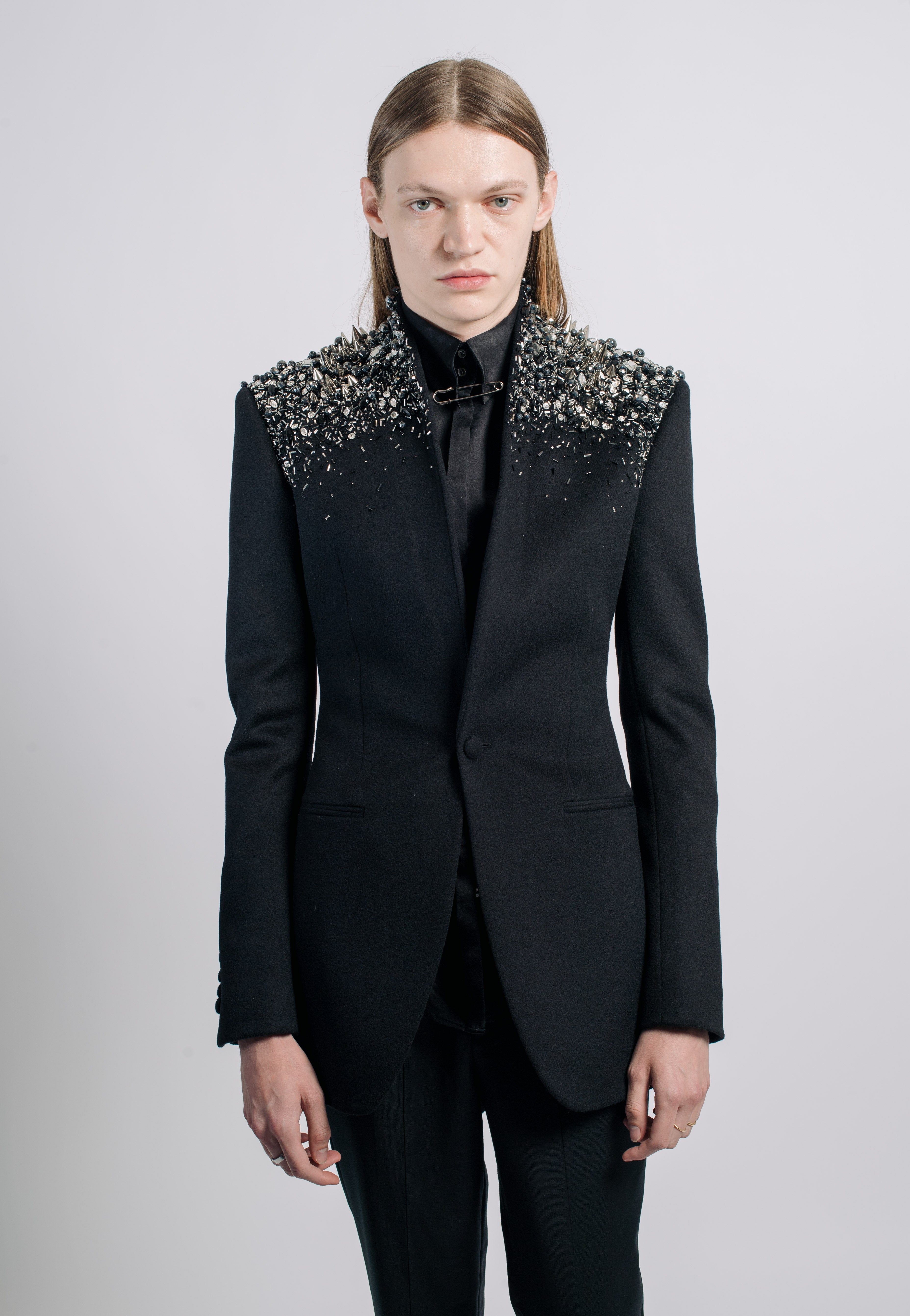 Black Crystal-Embellished Wool Blazer with sharp tailored lines, featuring a dramatic crystal-embellished shoulder design that creates a bold sculptural silhouette, exemplifying SHAO New York bespoke tailoring.