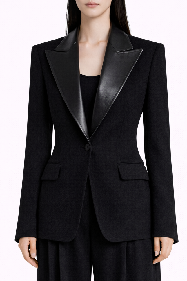 Black tuxedo jacket worn by a person on a white background