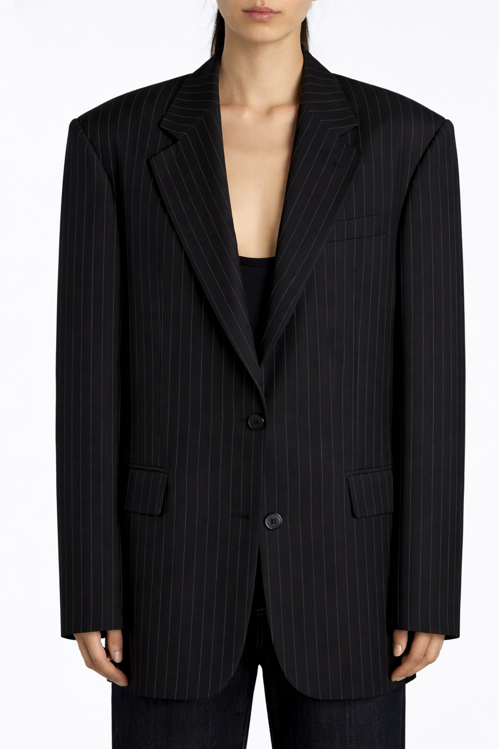 Black pinstripe blazer worn by a person on a white background
