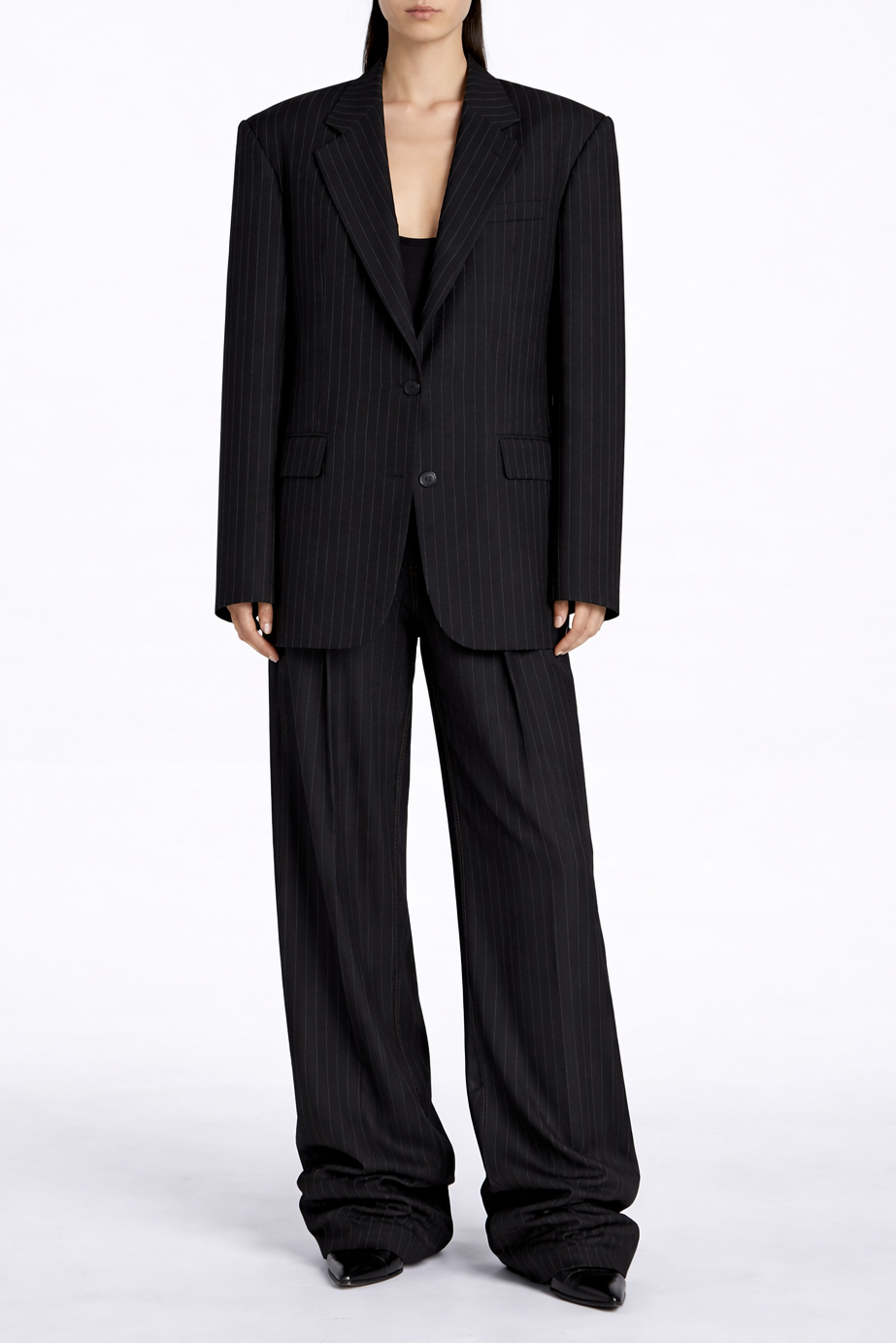 Person wearing a black pinstripe suit on a white background