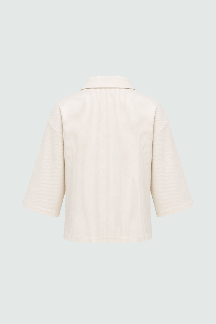 Cream Textured Pocket Polo Top shown from the back, highlighting its relaxed fit, elbow-length sleeves, and tailored collar in a luxe fabric reflecting SHAO New York bespoke tailoring.