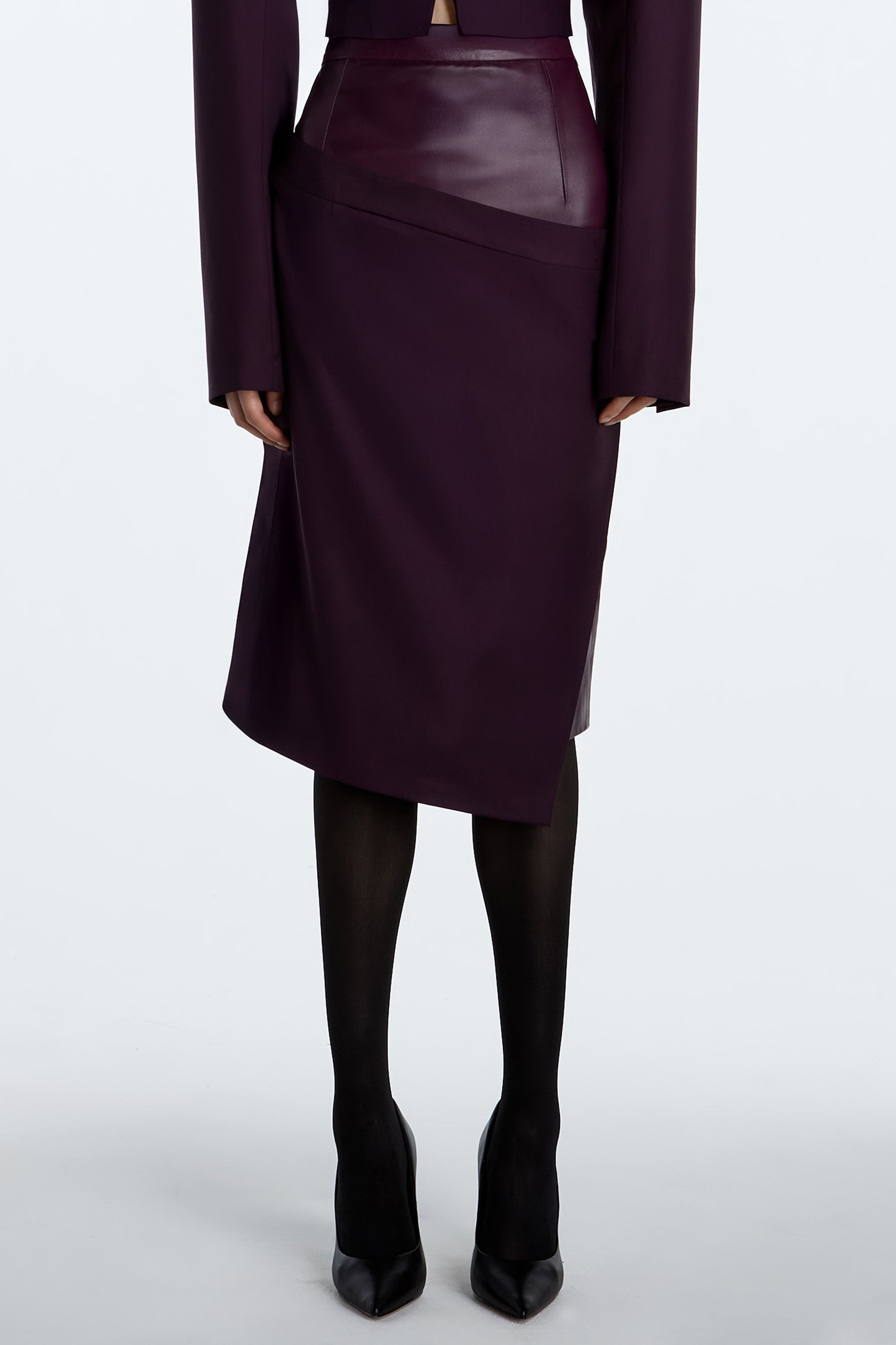 Aubergine Dual-Layer Asymmetrical Draped Skirt combining leather and wool in rich aubergine with sculptural silhouette.