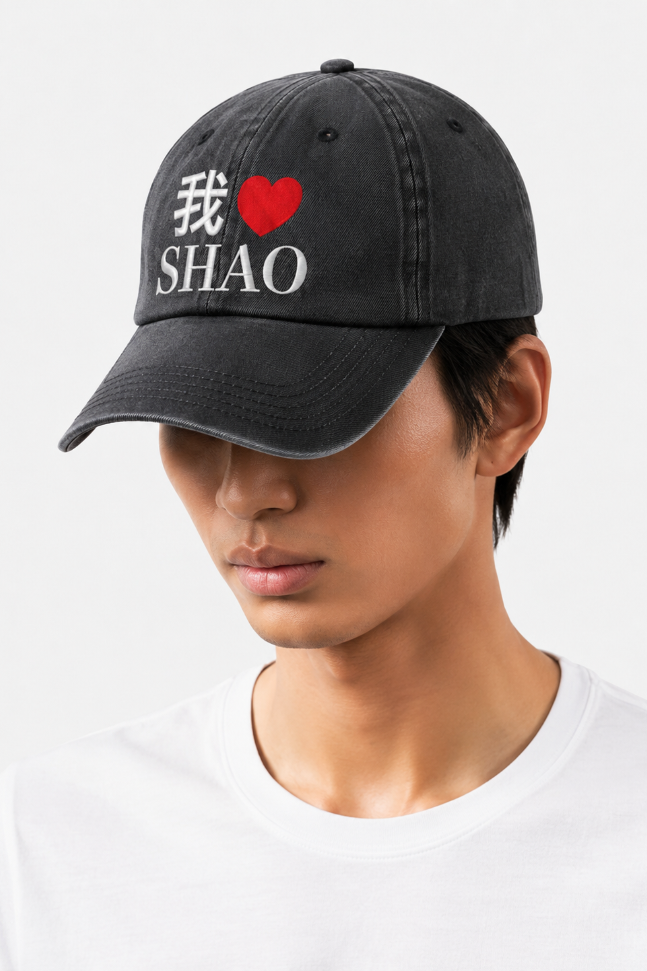 Model wearing the I Love SHAO Washed Denim Cap in a vintage black wash, featuring embroidered Chinese characters, a red heart, and SHAO branding for a casual urban style.