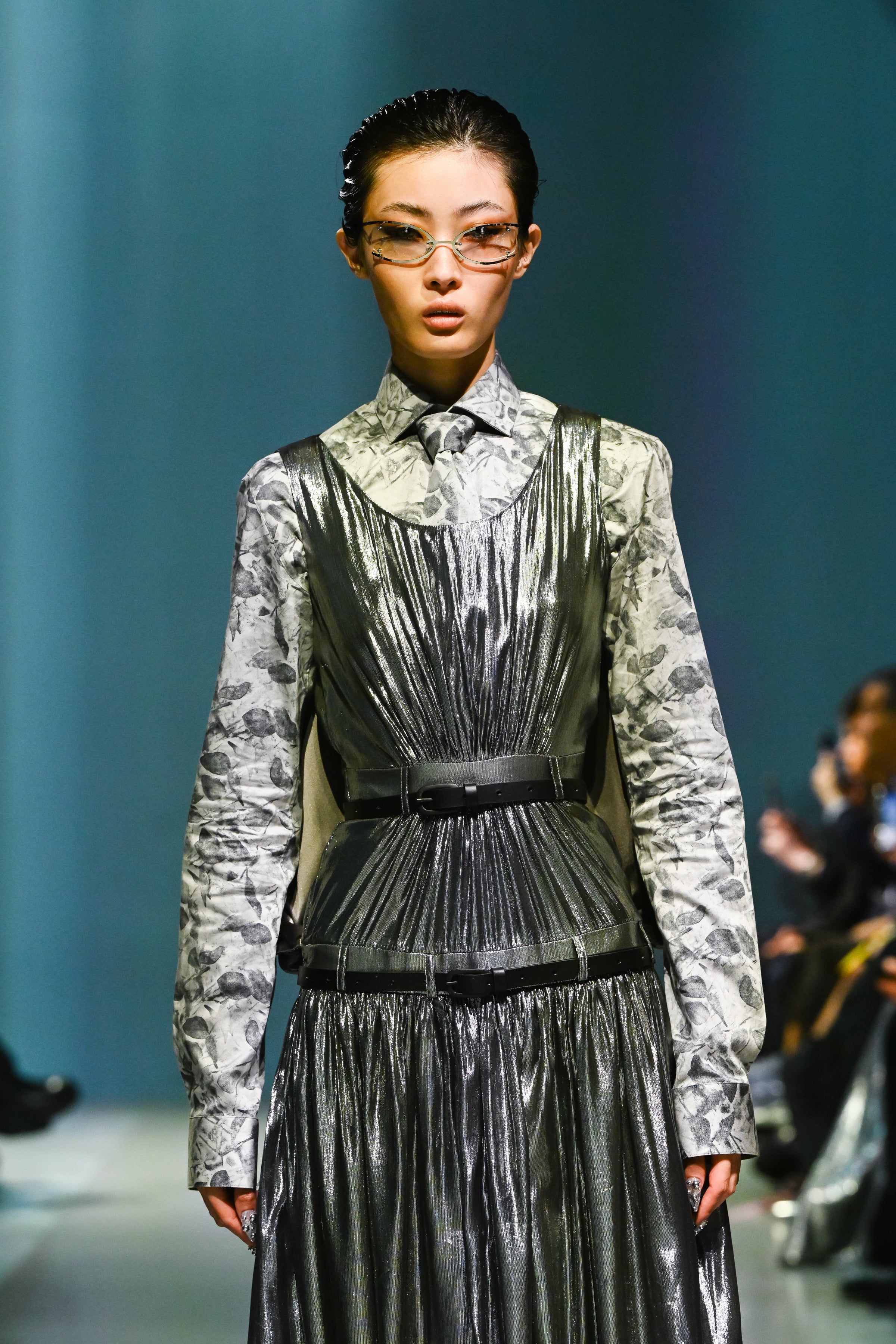 Model wearing the White Baroque Floral Print Shirt layered under a metallic pleated dress with black belts, showcasing SHAO New York luxury designer fashion and bespoke tailoring.