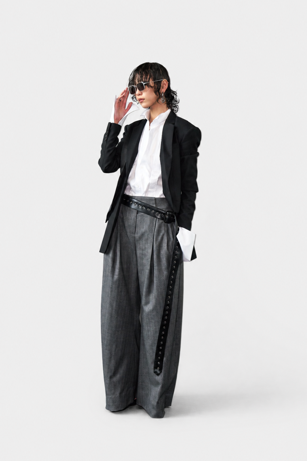 Model wearing White Tailored Tuxedo Shirt styled with a black modern tailored jacket and wide-leg gray trousers featuring a bold black belt, embodying SHAO New York bespoke tailoring and luxury designer fashion.