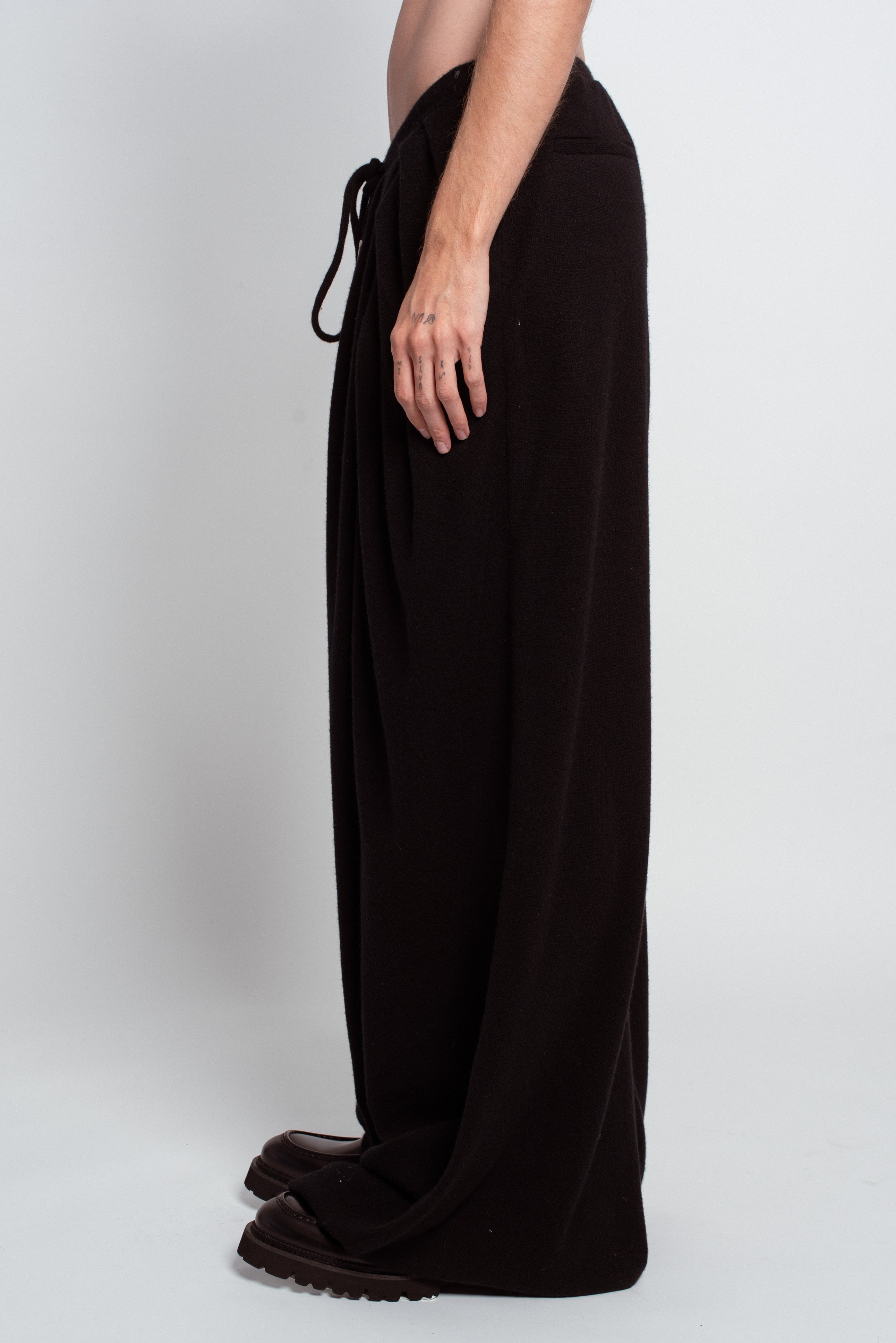 Side profile of Black Cashmere Wide-Leg Pants with a relaxed drawstring waist, flowing soft fabric, and an elongated silhouette, highlighting SHAO New York bespoke tailoring and luxury designer fashion.