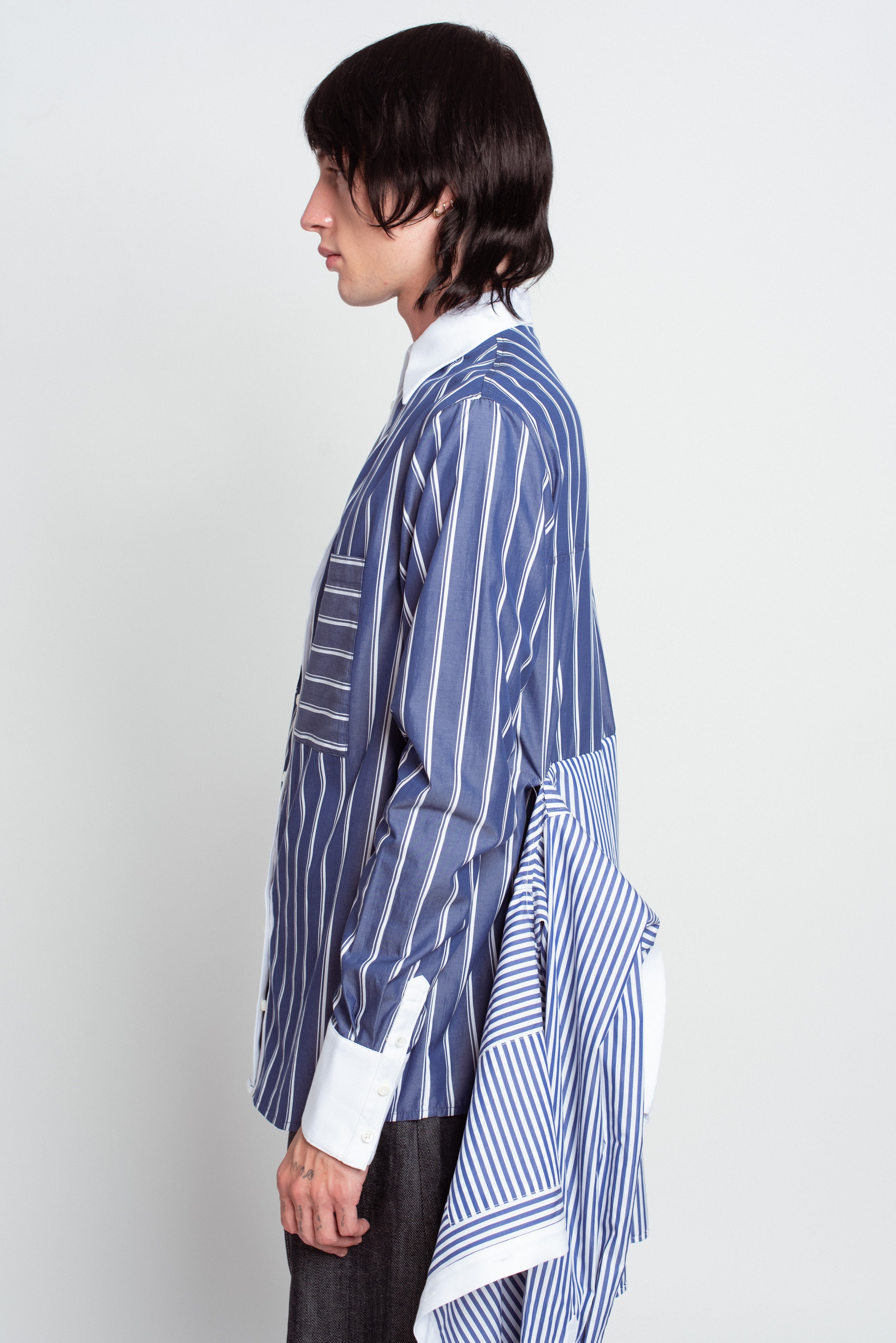 Side profile of Blue Pinstripe Layered Shirt – Attached Back Construction featuring mixed stripe patterns, crisp white collar and cuffs, and an innovative draped back detail showcasing SHAO New York bespoke tailoring and luxury designer fashion.