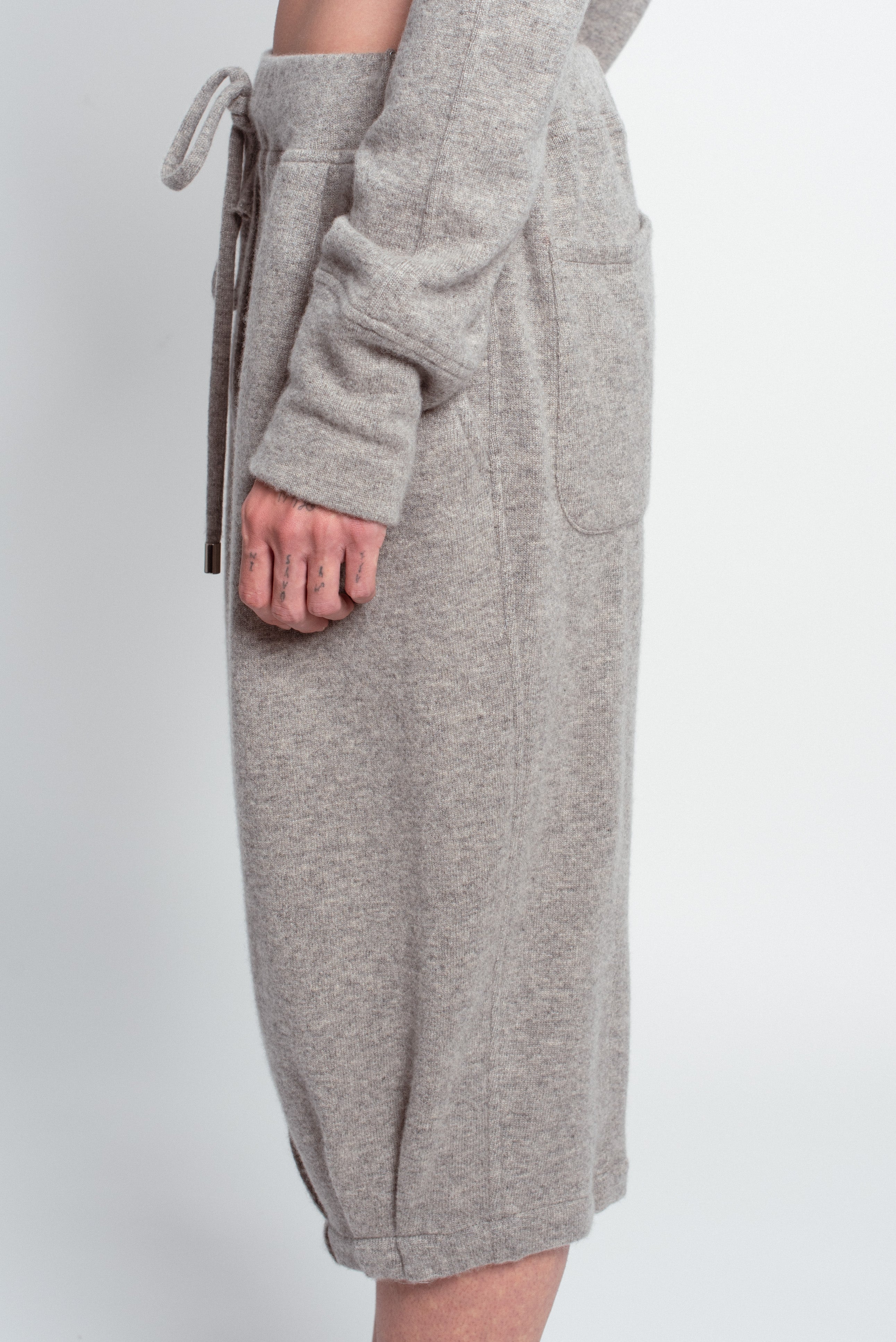 Side view of Grey Cashmere Wide-Leg Pants with a relaxed fit, featuring a drawstring waist, soft texture, and a minimalist pocket, showcasing SHAO New York bespoke tailoring and luxury designer fashion.