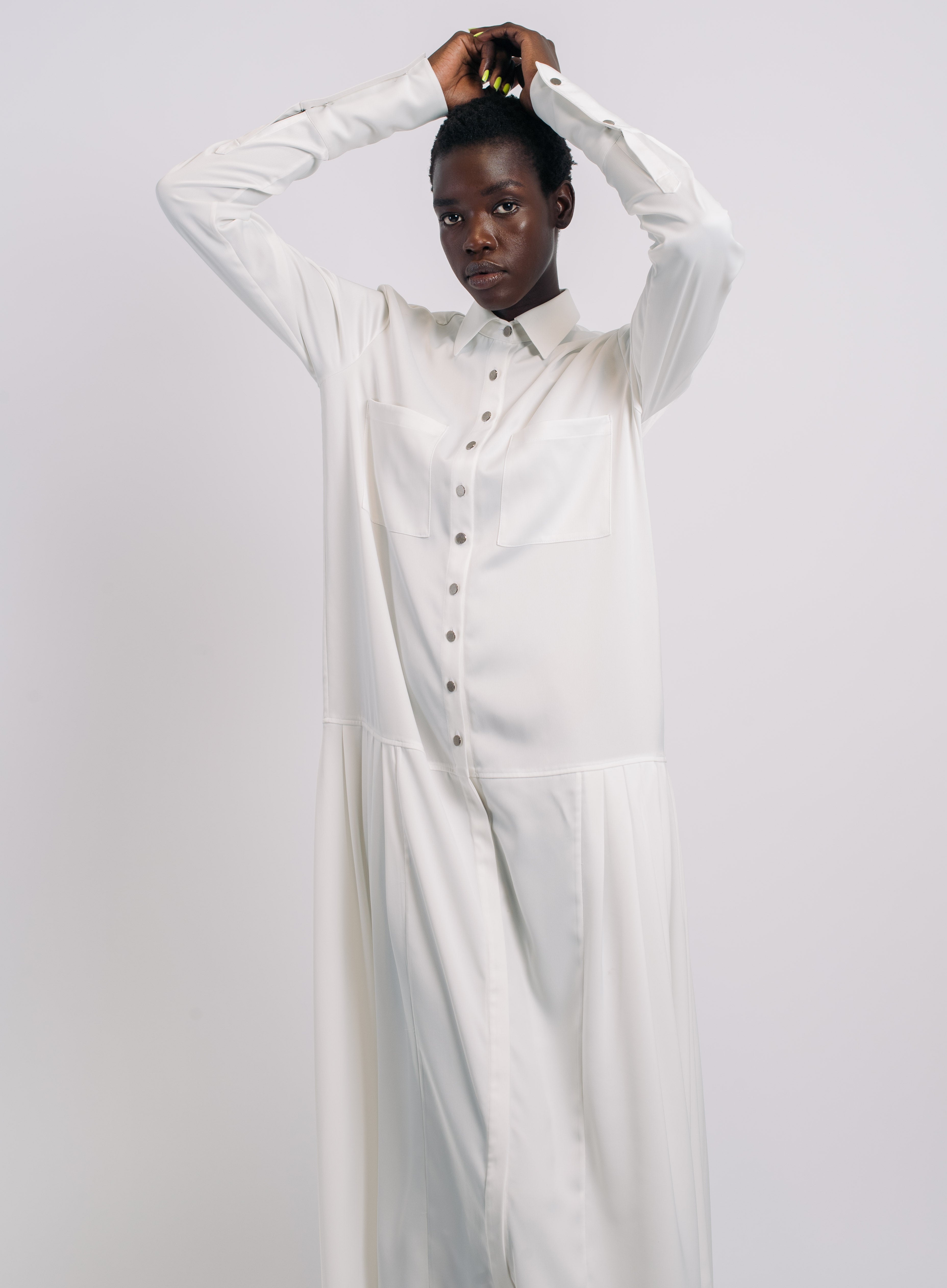 White Pleated Shirt Dress featuring a minimalist silhouette with a pointed collar, front button closure, subtle pleating on the skirt, and crafted to highlight SHAO New York bespoke tailoring and luxury designer fashion.